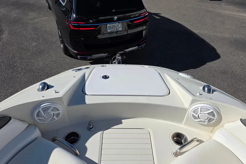 Slide: The Image of 2010 Sea Ray 260 Sundeck boat hitched to a black SUV in a parking lot. - 11