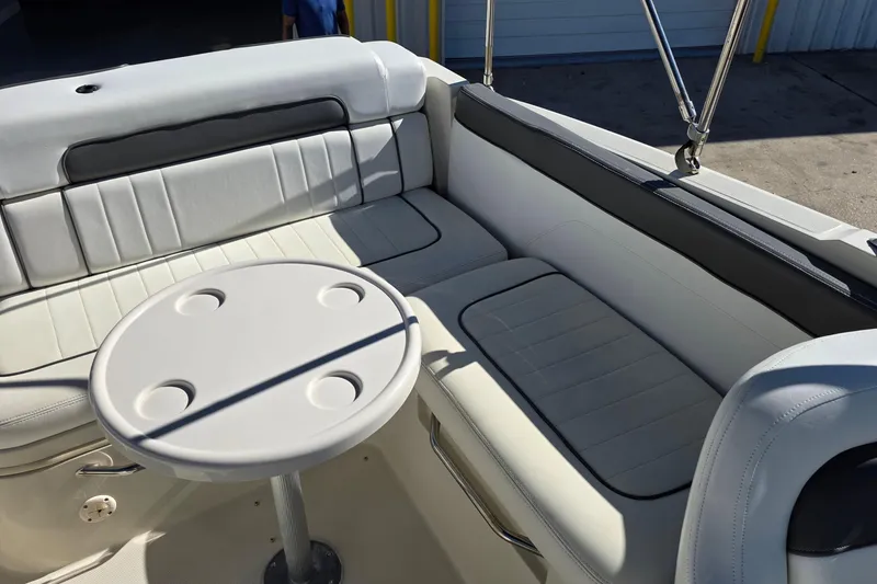 Slide: The Image of 2010 Sea Ray 260 Sundeck interior with white seating and round table. - 14