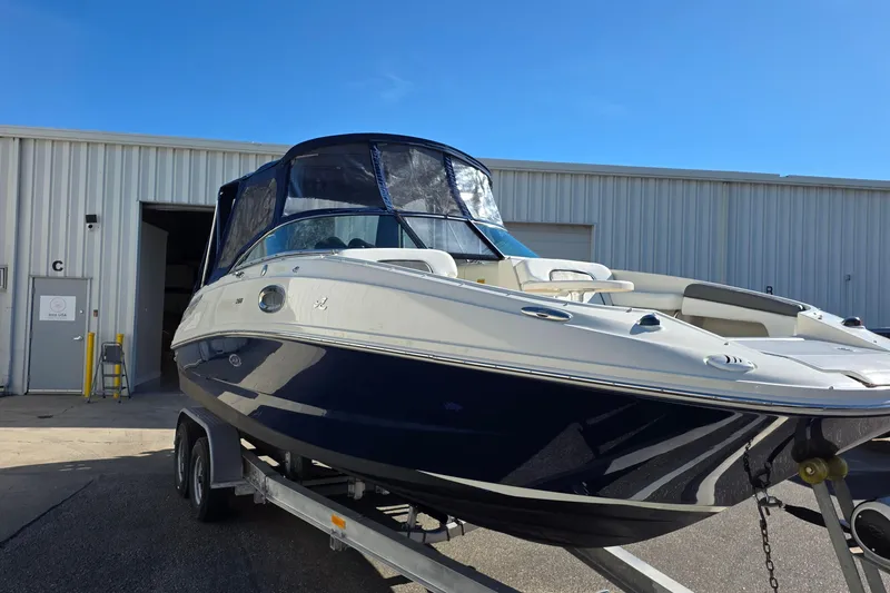Slide: The Image of 2010 Sea Ray 260 Sundeck boat on trailer, parked outside industrial building. - 15