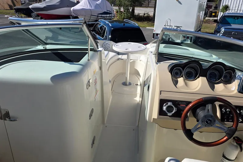 Slide: The Image of 2010 Sea Ray 260 Sundeck interior with steering wheel and dashboard view. - 24