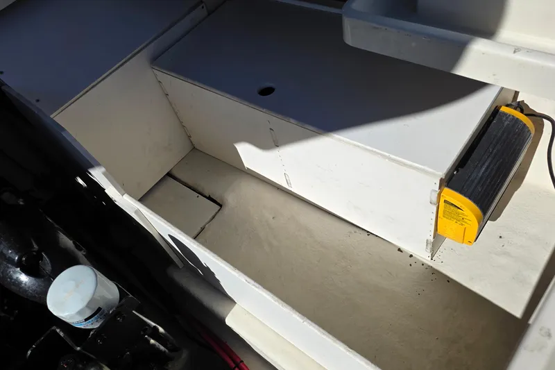 Slide: The Image of 2010 Sea Ray 260 Sundeck interior storage compartment with visible equipment. - 44