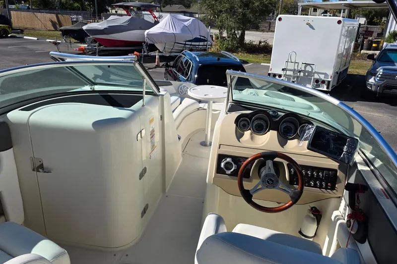 Slide: The Image of 2010 Sea Ray 260 Sundeck boat interior with steering wheel and dashboard controls. - 8