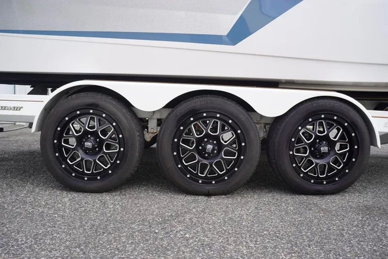 Slide: The Image of Triple axle trailer with stylish black wheels for 2023 Tigé 24RZX boat. - 102