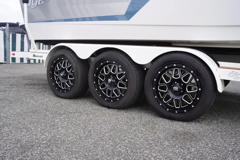Slide: The Image of 2023 Tigé 24RZX boat trailer with stylish black alloy wheels. - 103