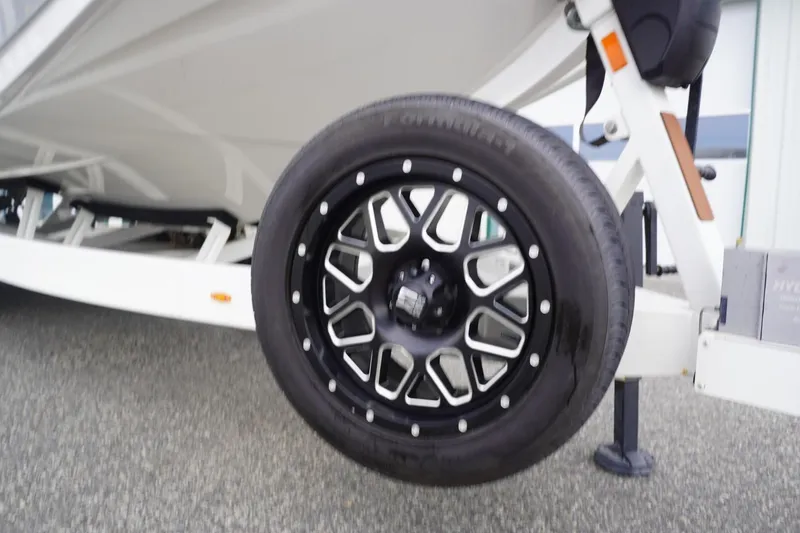 Slide: The Image of 2023 Tigé 24RZX boat trailer with stylish black wheel design. - 104