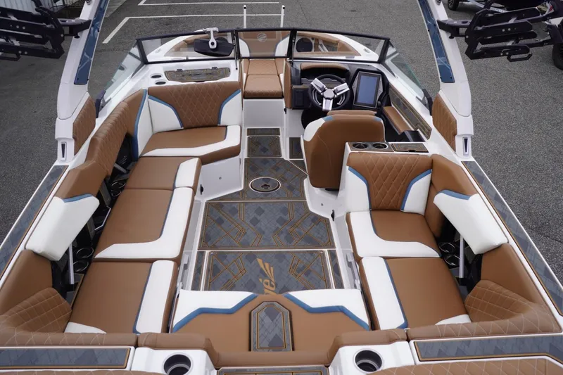 Slide: The Image of 2023 Tigé 24RZX boat interior with luxurious brown and white seating, modern dashboard. - 106