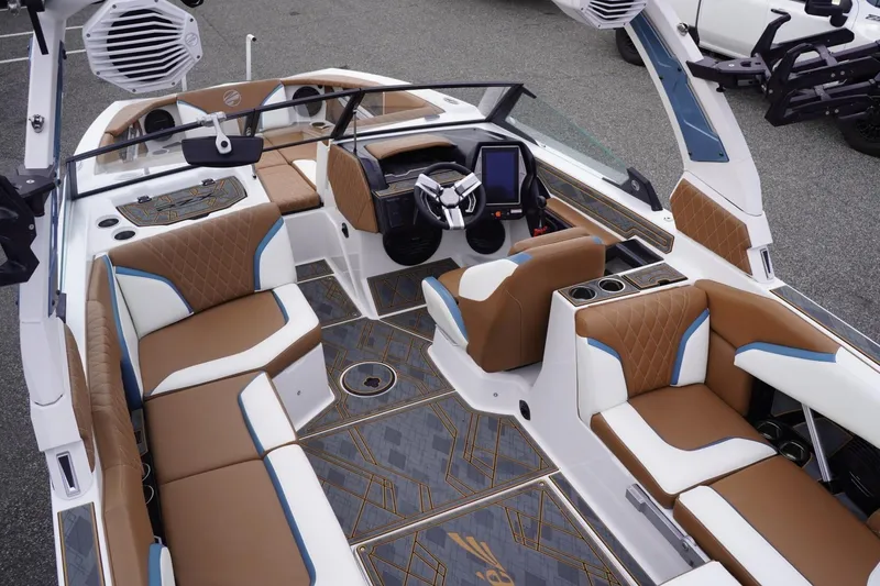 Slide: The Image of 2023 Tigé 24RZX boat interior with luxurious brown and white seating, modern dashboard. - 107