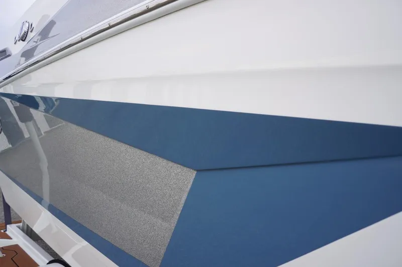 Slide: The Image of 2023 Tigé 24RZX boat with sleek blue and gray exterior design. - 14