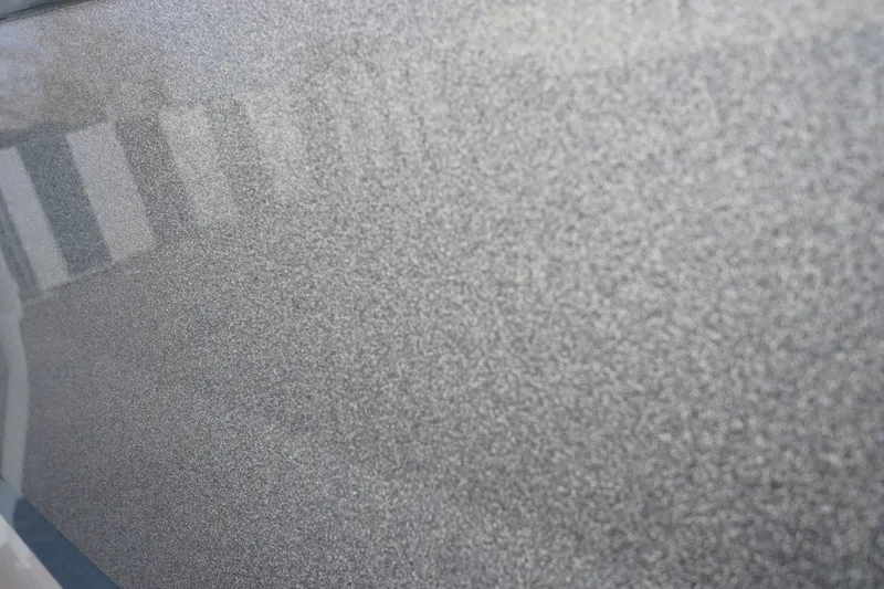 Slide: The Image of Close-up of 2023 Tigé 24RZX boat's metallic silver paint texture. - 15