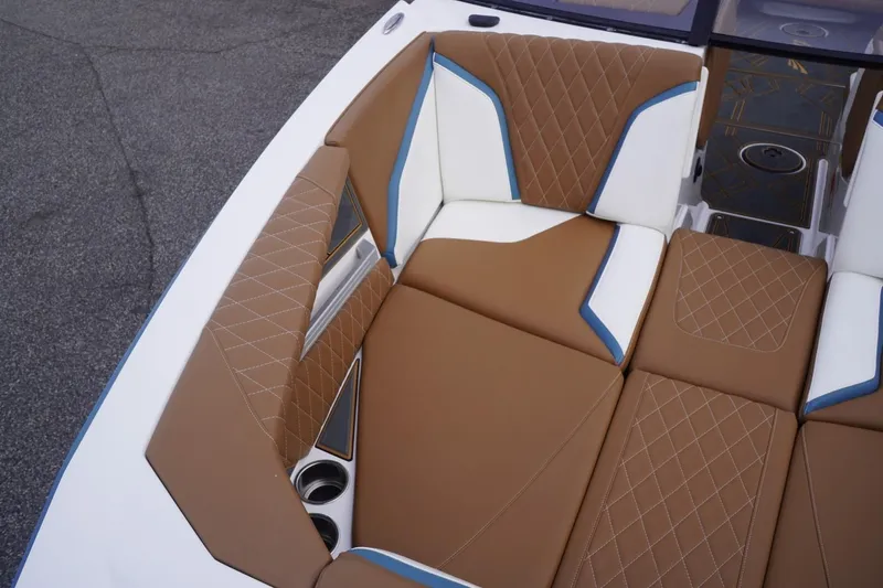 Slide: The Image of 2023 Tigé 24RZX boat interior with brown and white diamond-stitched seating. - 22