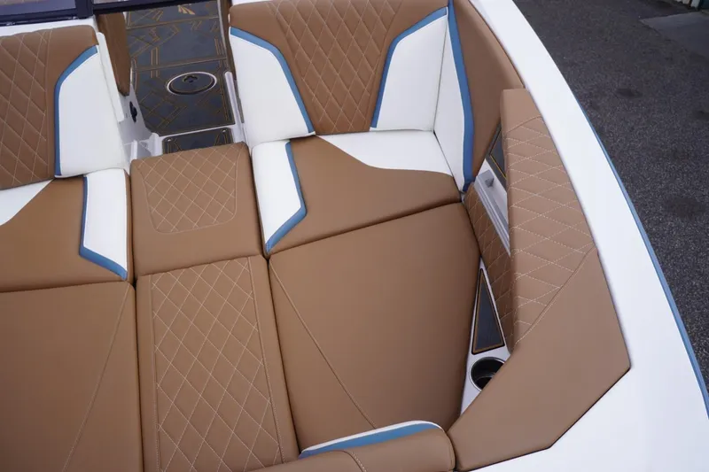 Slide: The Image of 2023 Tigé 24RZX boat interior with brown and white diamond-stitched seating. - 23