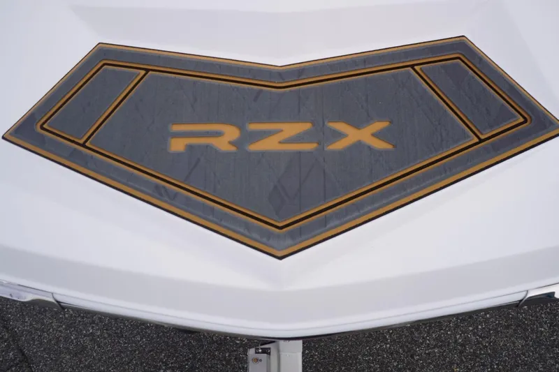 Slide: The Image of 2023 Tigé 24RZX boat logo on deck, featuring bold RZX lettering. - 24