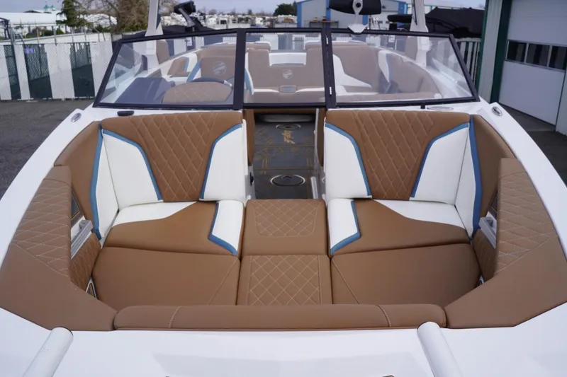 Slide: The Image of 2023 Tigé 24RZX boat interior with luxurious brown and white seating, blue accents. - 25