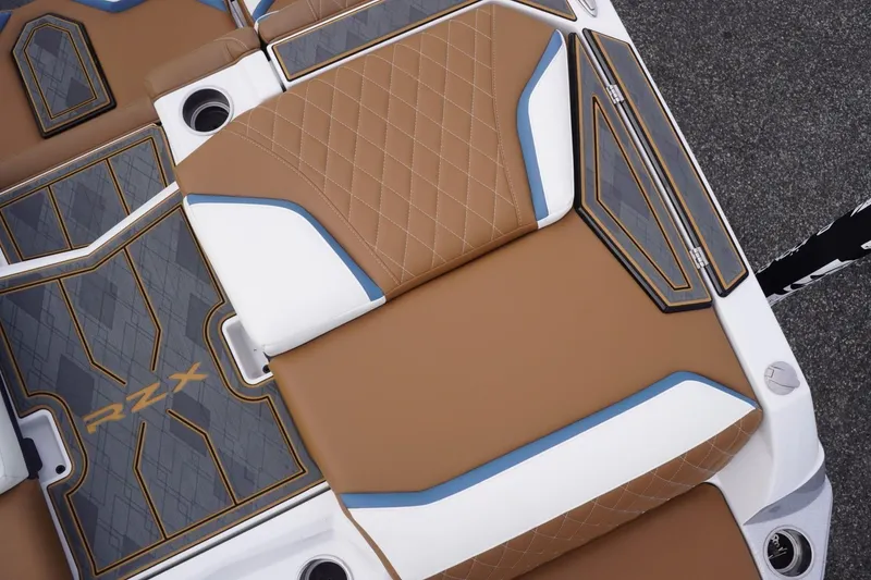 Slide: The Image of 2023 Tigé 24RZX boat interior with brown and white diamond-stitched upholstery. - 28