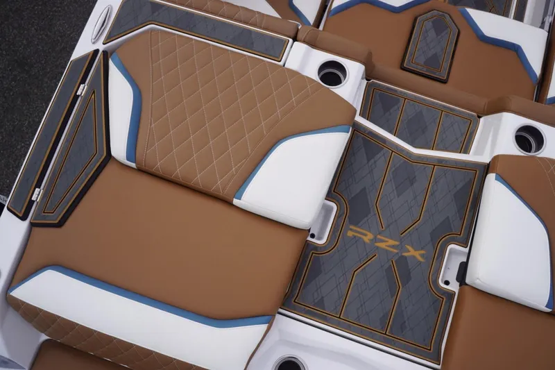 Slide: The Image of 2023 Tigé 24RZX boat interior with brown and white diamond-stitched upholstery. - 29