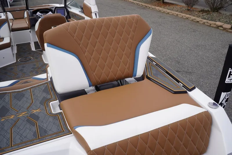 Slide: The Image of 2023 Tigé 24RZX boat interior with brown diamond-stitched seating and modern design. - 30