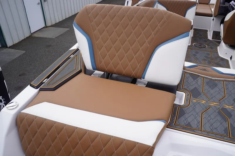 Slide: The Image of 2023 Tigé 24RZX boat interior with brown and white diamond-stitched seating. - 31