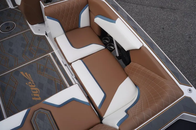 Slide: The Image of 2023 Tigé 24RZX boat interior with brown and white cushioned seating. - 32