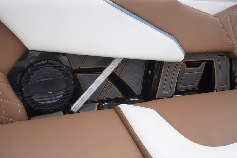 Slide: The Image of 2023 Tigé 24RZX interior with brown and white seating, featuring a built-in speaker system. - 38