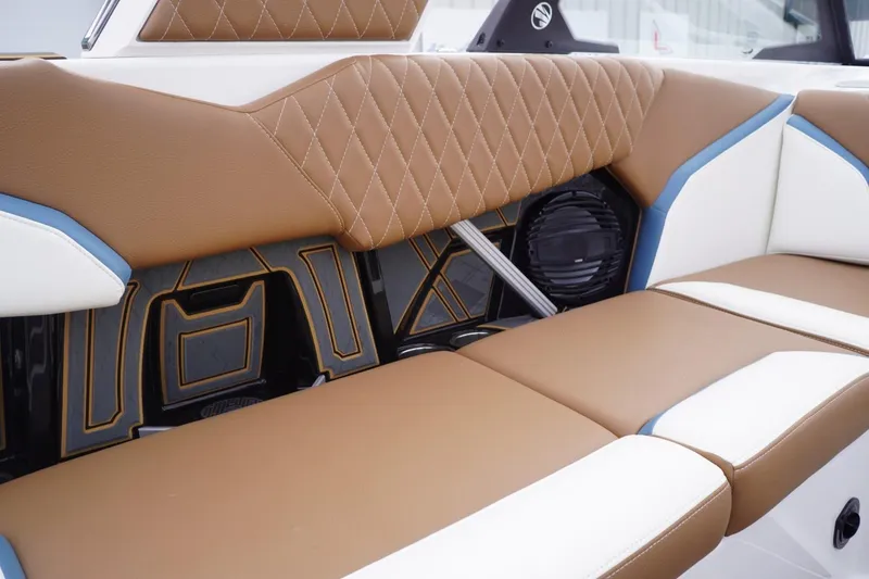 Slide: The Image of 2023 Tigé 24RZX boat interior with brown and white cushioned seating. - 39