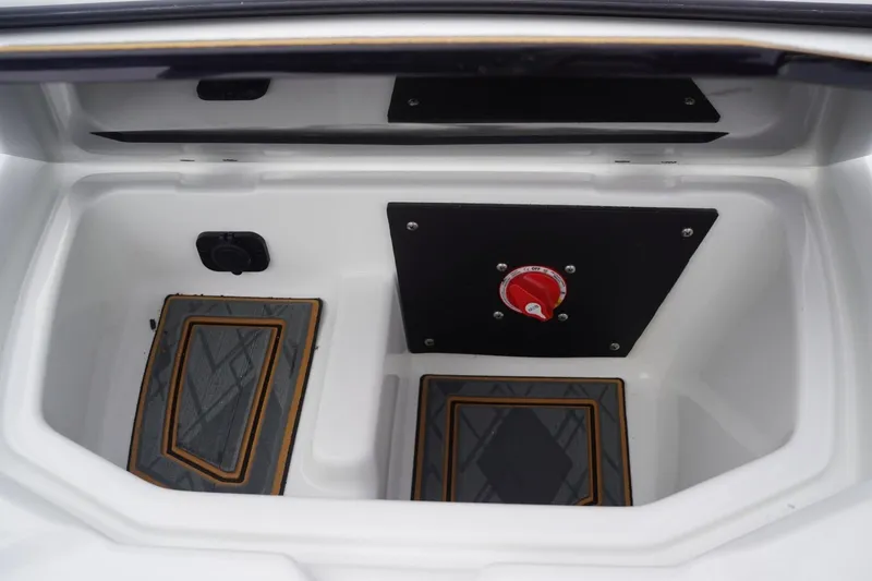 Slide: The Image of 2023 Tigé 24RZX storage compartment with red control knob and custom flooring. - 46