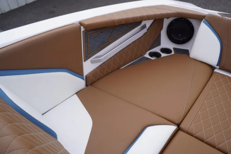 Slide: The Image of 2023 Tigé 24RZX boat interior with brown and white cushioned seating. - 48