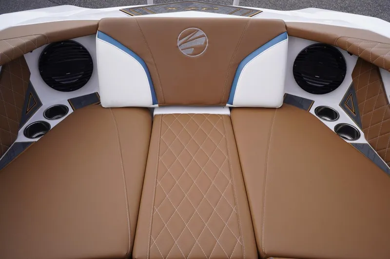 Slide: The Image of 2023 Tigé 24RZX boat interior with brown diamond-stitched upholstery and integrated speakers. - 49