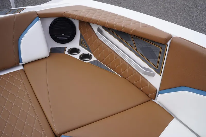 Slide: The Image of 2023 Tigé 24RZX boat interior with brown diamond-stitched upholstery and cup holders. - 50
