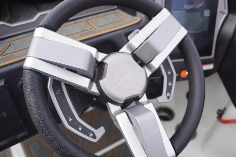 Slide: The Image of Steering wheel of 2023 Tigé 24RZX boat with modern controls and sleek design. - 54