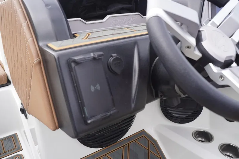 Slide: The Image of 2023 Tigé 24RZX boat dashboard with steering wheel and control panel. - 55