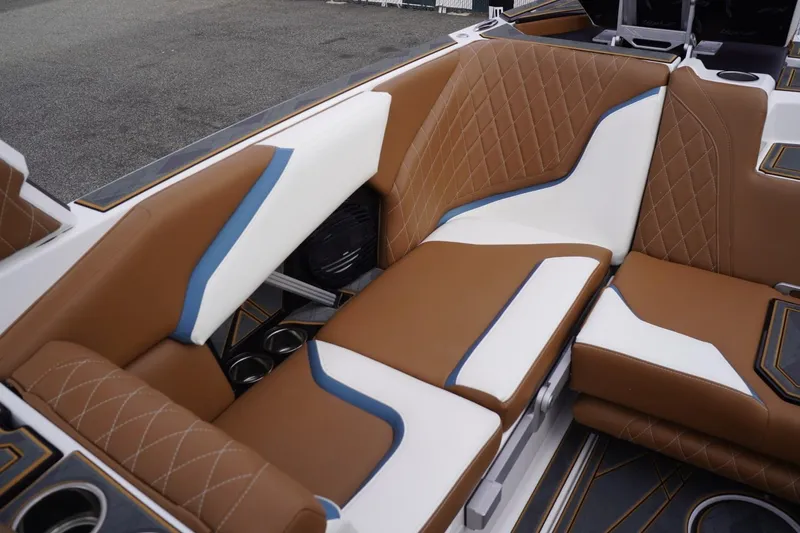 Slide: The Image of 2023 Tigé 24RZX boat interior with brown, white, and blue leather seating. - 59
