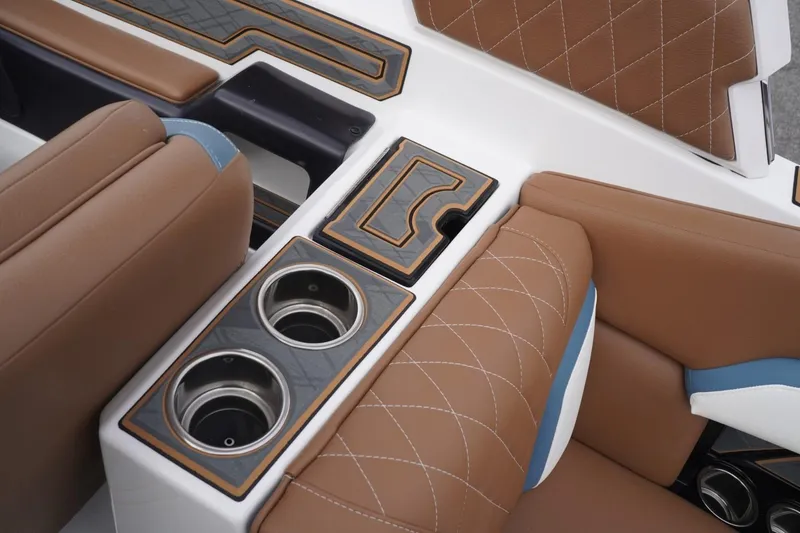 Slide: The Image of 2023 Tigé 24RZX boat interior with brown leather seats and cup holders. - 63