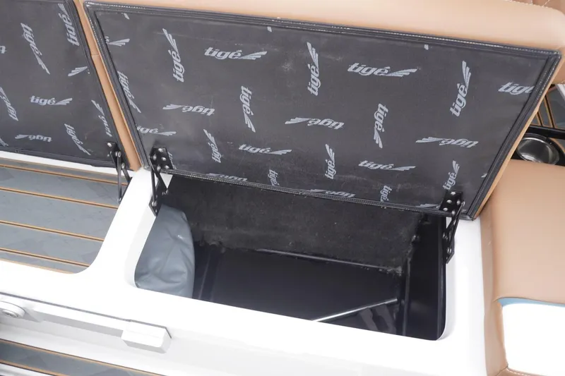 Slide: The Image of Open storage compartment in 2023 Tigé 24RZX boat with branded interior lining. - 68