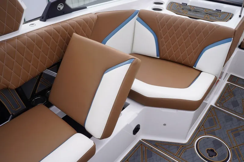 Slide: The Image of 2023 Tigé 24RZX boat interior with brown, white, and blue cushioned seating. - 69
