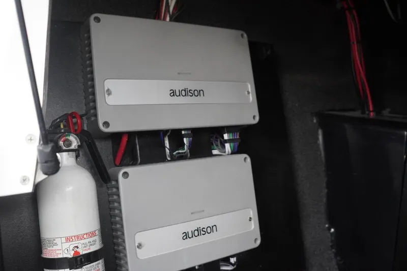 Slide: The Image of 2023 Tigé 24RZX audio system with Audison amplifiers and fire extinguisher. - 73