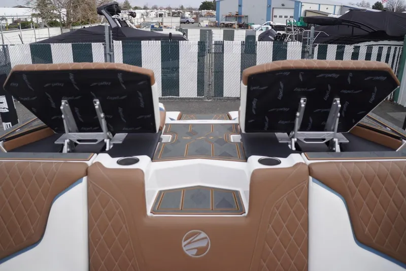 Slide: The Image of 2023 Tigé 24RZX boat interior with brown leather seats and cup holders. - 79