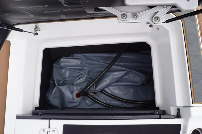 Slide: The Image of Storage compartment of 2023 Tigé 24RZX boat with folded equipment inside. - 86