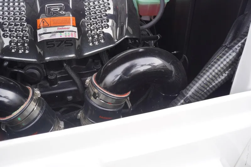 Slide: The Image of 2023 Tigé 24RZX engine close-up, featuring Indmar 575 components and hoses. - 88
