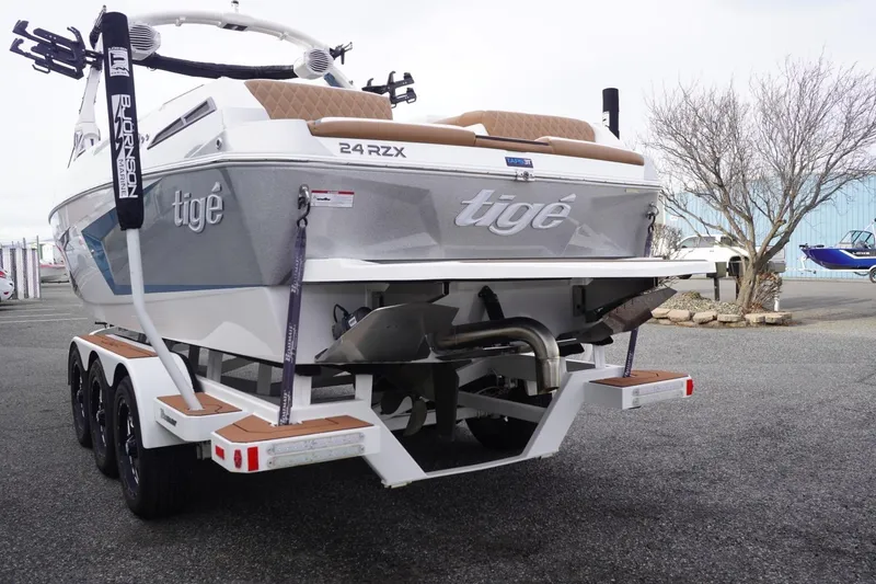 Slide: The Image of 2023 Tigé 24RZX boat on trailer, rear view, in a parking lot. - 9