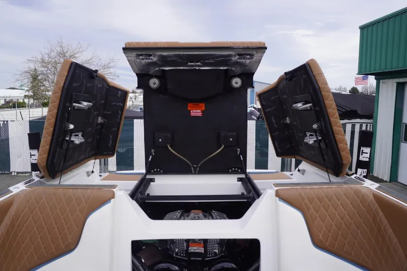 Slide: The Image of 2023 Tigé 24RZX boat engine compartment with open hatches, showcasing interior details. - 90