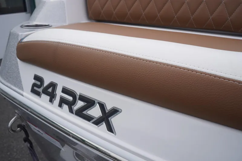 Slide: The Image of 2023 Tigé 24RZX boat with brown and white seating detail. - 92