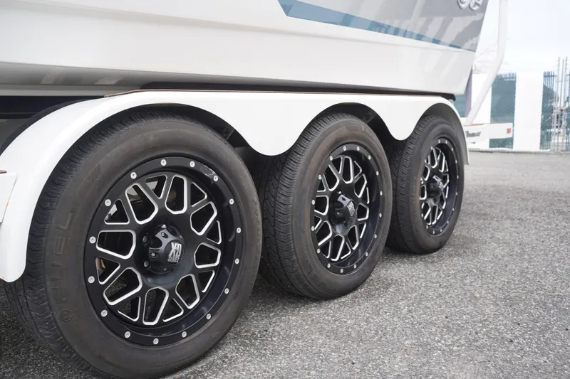 Slide: The Image of Triple axle trailer with stylish black wheels for 2023 Tigé 24RZX boat. - 98