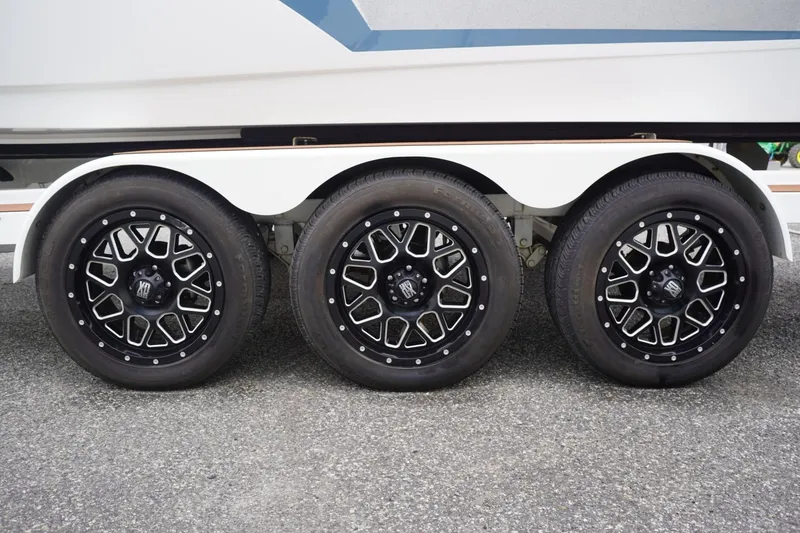 Slide: The Image of Triple axle trailer with stylish black wheels for 2023 Tigé 24RZX boat. - 99