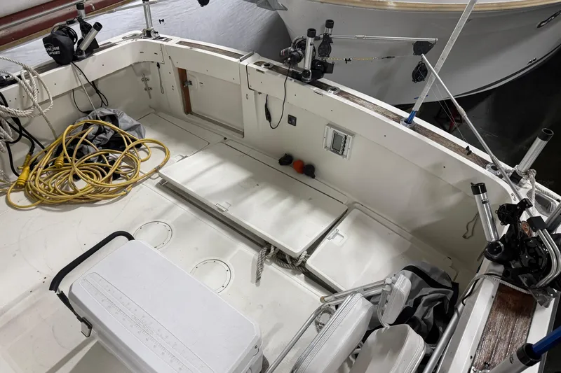 Slide: The Image of 1989 Tiara Yachts 3600 Open boat deck with fishing gear and storage compartments. - 15