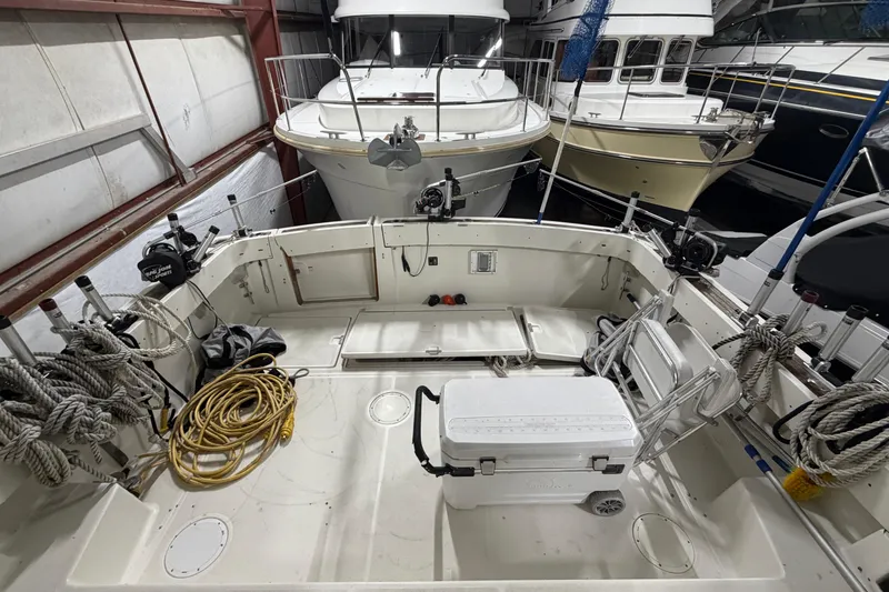 Slide: The Image of 1989 Tiara Yachts 3600 Open in storage, featuring spacious deck and nautical equipment. - 16