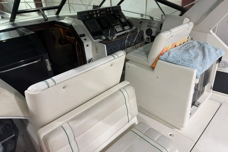 Slide: The Image of 1989 Tiara Yachts 3600 Open interior with helm, seating, and control panel. - 20