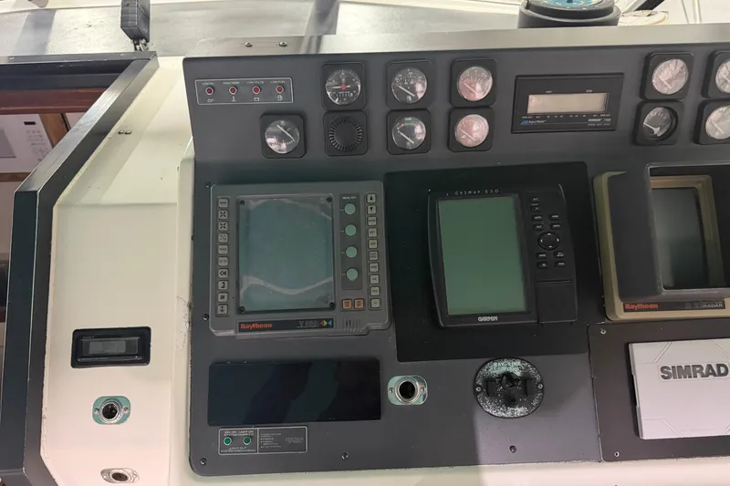 Slide: The Image of Control panel of a 1989 Tiara Yachts 3600 Open with navigation instruments. - 24