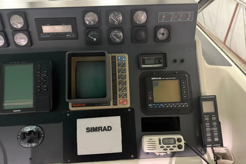 Slide: The Image of Dashboard of a 1989 Tiara Yachts 3600 Open with navigation and control instruments. - 25