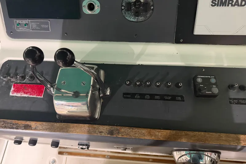 Slide: The Image of Control panel of a 1989 Tiara Yachts 3600 Open with dual throttle levers. - 26