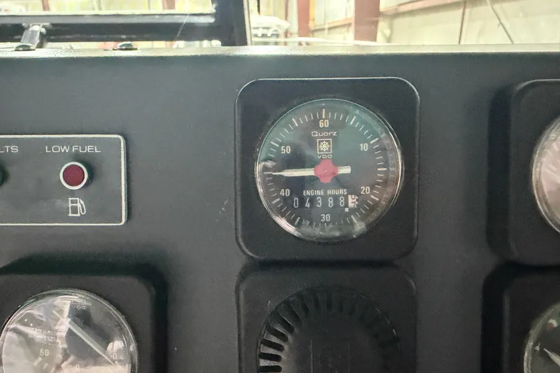 Slide: The Image of Dashboard of 1989 Tiara Yachts 3600 Open showing engine hours and low fuel indicator. - 29